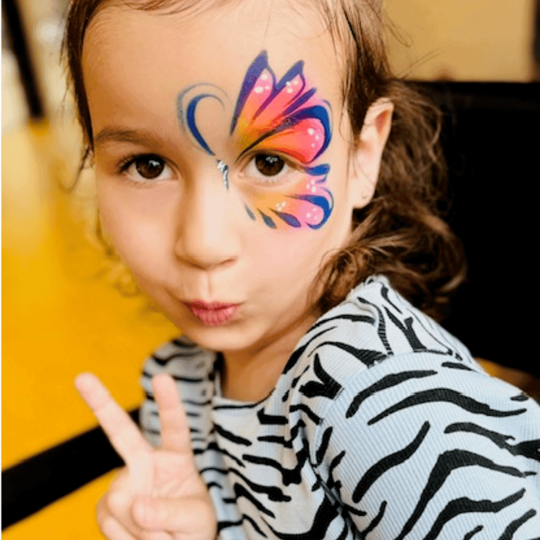 Meisje met een vlindervleugel in oranje en paars naast haar oog